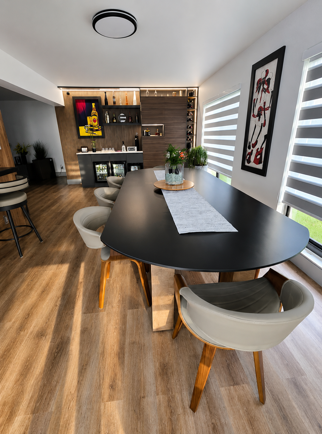Dining room bar storage with custom cabinetry, display lighting, and wine storage