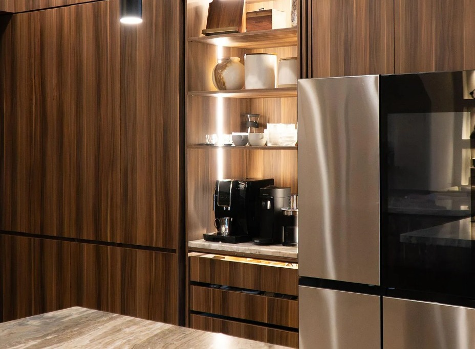 Integrated coffee station with illuminated shelving and hidden appliance cabinetry